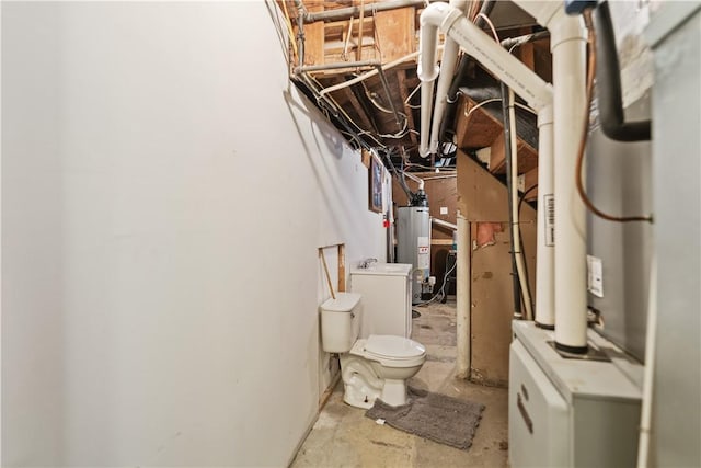 bathroom featuring washer / dryer, concrete flooring, and water heater