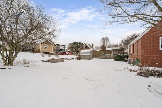 snowy yard with a shed