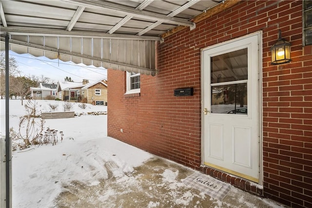 view of snow covered property entrance