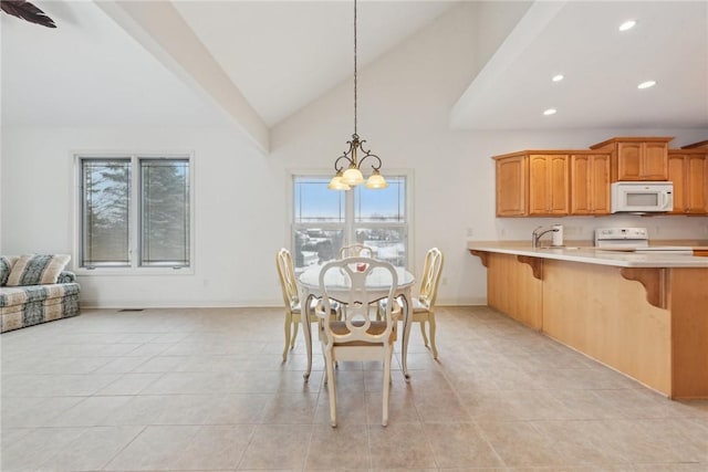 dining space featuring an inviting chandelier, sink, high vaulted ceiling, and light tile patterned floors