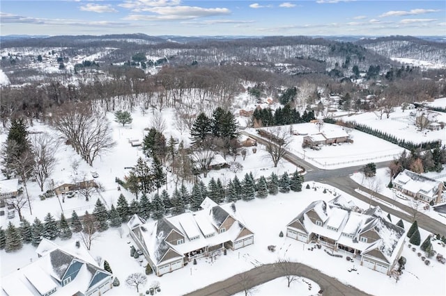 snowy aerial view with a mountain view