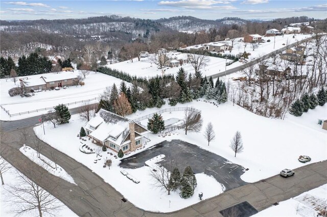 snowy aerial view with a mountain view