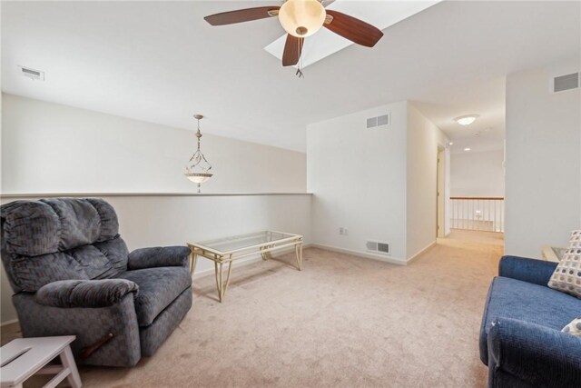 sitting room featuring ceiling fan and light colored carpet