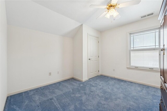 bonus room with lofted ceiling, ceiling fan, and dark colored carpet