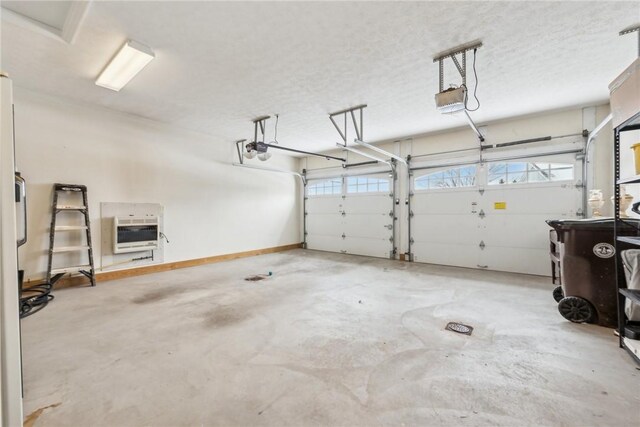 garage with a garage door opener and heating unit