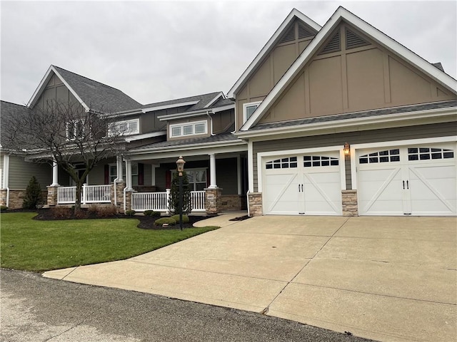 craftsman house with a porch, a garage, and a front lawn