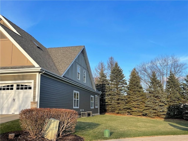 view of home's exterior featuring central AC, a garage, and a lawn