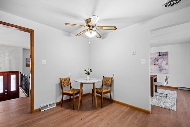 dining area with ceiling fan and hardwood / wood-style flooring