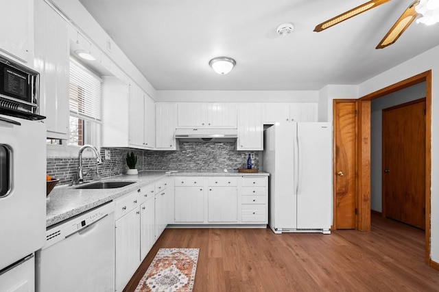 kitchen featuring white cabinets, light wood-type flooring, white appliances, and sink