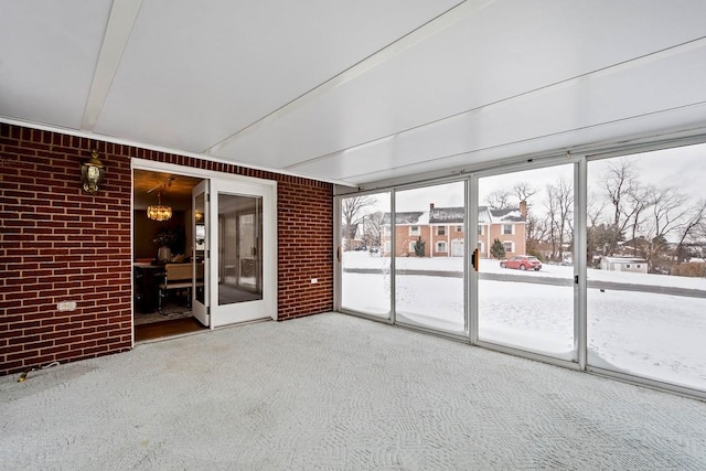 unfurnished sunroom featuring a notable chandelier