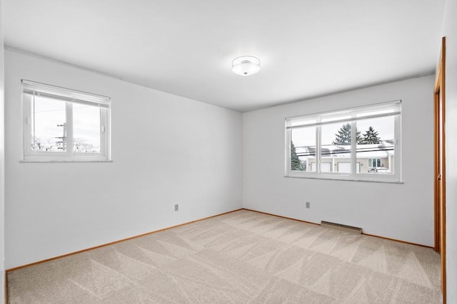 unfurnished room featuring light colored carpet