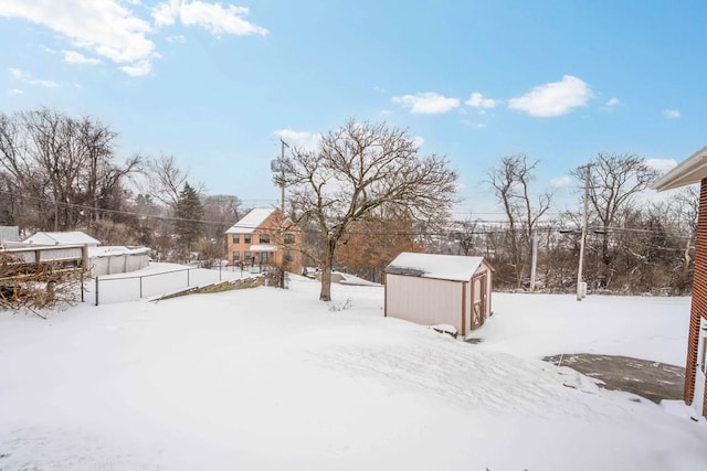 yard layered in snow with an outdoor structure