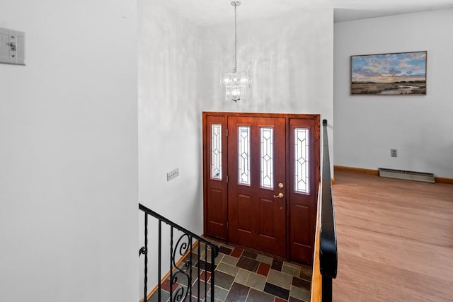 entryway with a baseboard radiator and a chandelier