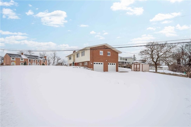 yard covered in snow with a storage shed