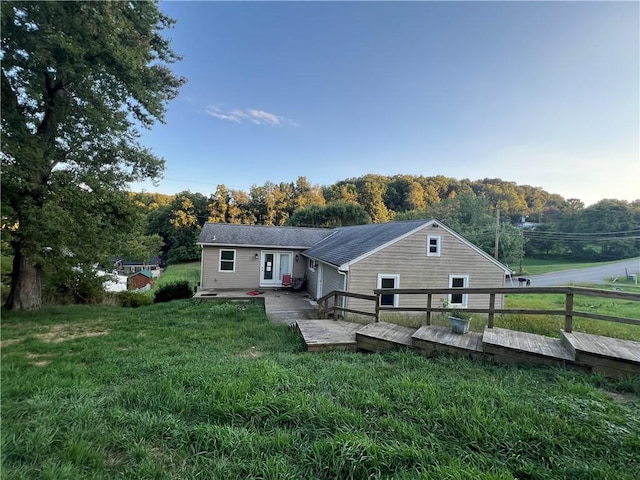 back of house featuring a yard and a wooden deck