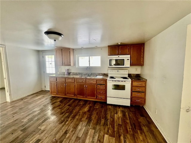 kitchen featuring dark hardwood / wood-style flooring, sink, and white appliances