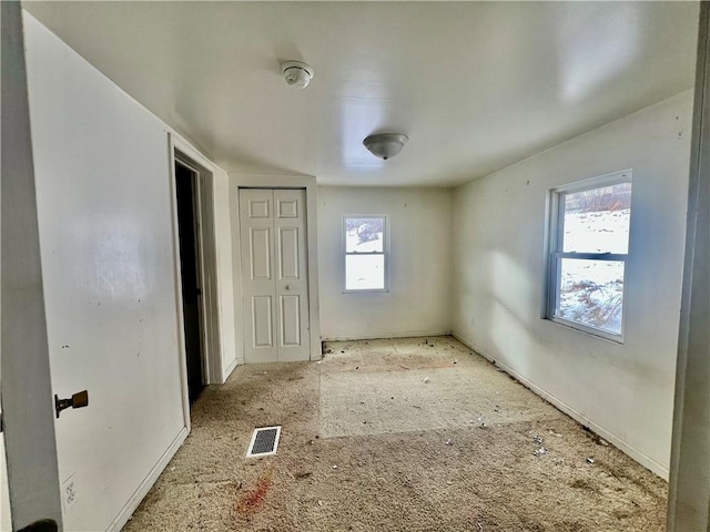 unfurnished bedroom with multiple windows