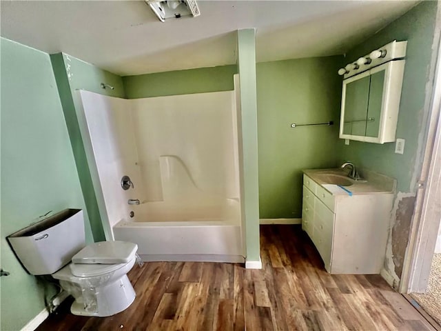 full bathroom with shower / tub combination, hardwood / wood-style flooring, vanity, and toilet