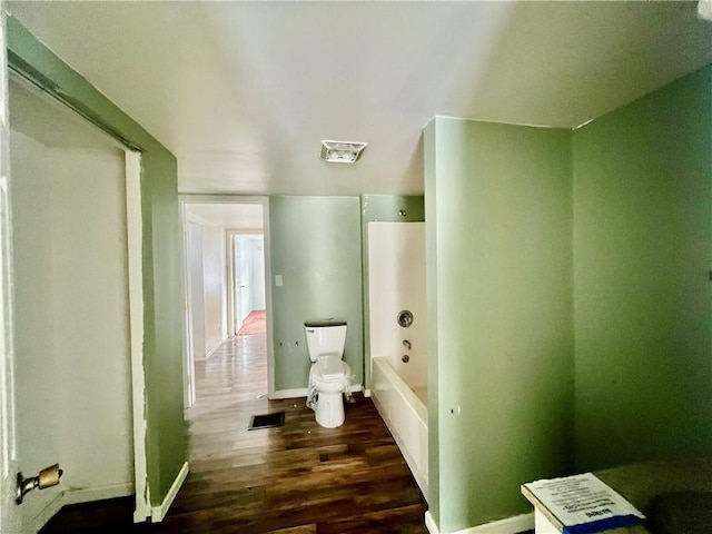 bathroom with hardwood / wood-style floors and toilet