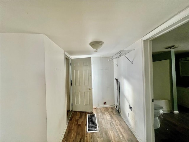 laundry room featuring wood-type flooring