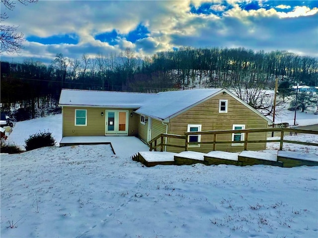 snow covered property featuring a deck