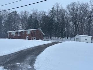 yard layered in snow with an outdoor structure