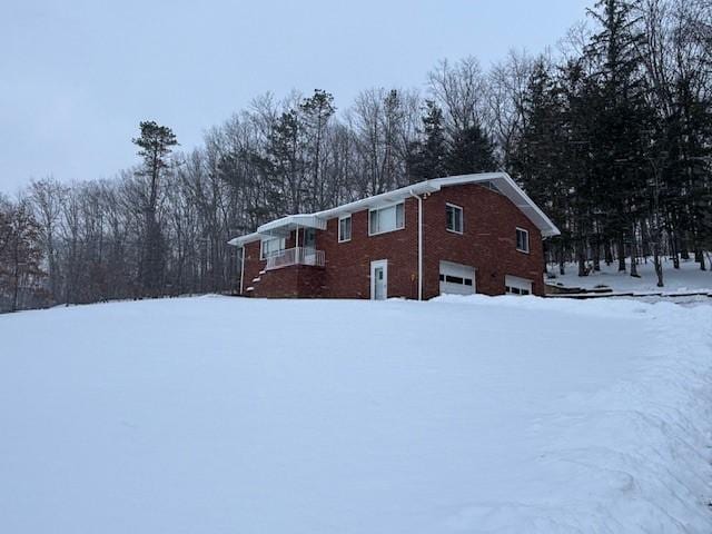 view of snowy exterior with a garage