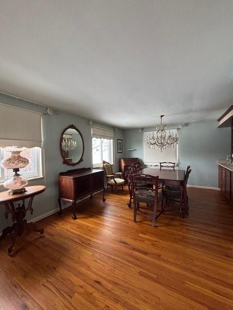 dining room with hardwood / wood-style floors and a chandelier