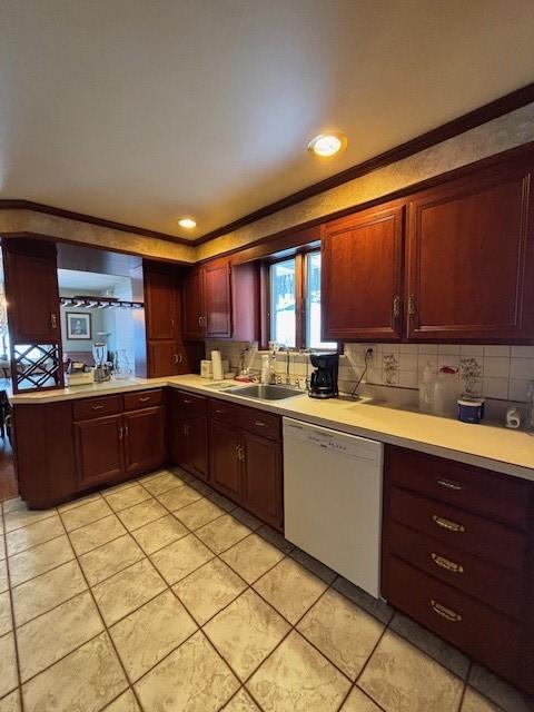 kitchen with sink, light tile patterned floors, ornamental molding, white dishwasher, and backsplash