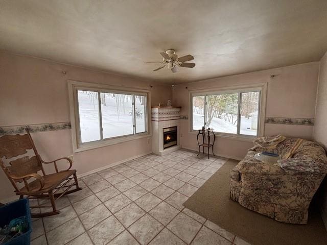 sitting room featuring ceiling fan and light tile patterned flooring