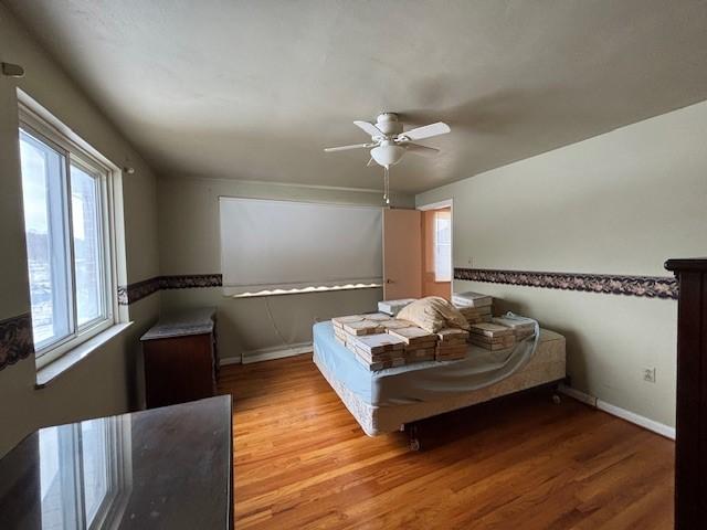 bedroom featuring ceiling fan and light hardwood / wood-style flooring