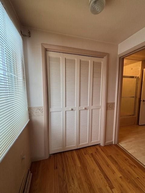 unfurnished bedroom featuring hardwood / wood-style flooring and a closet