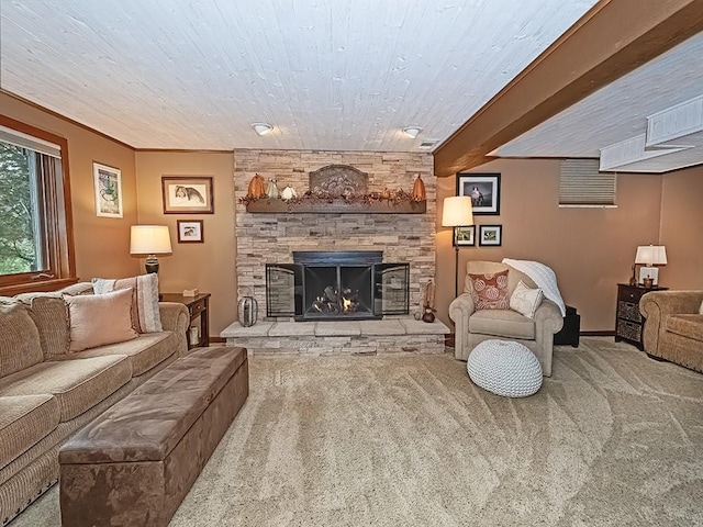 carpeted living room featuring beam ceiling, crown molding, and a fireplace