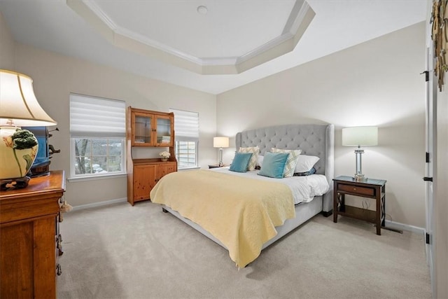 carpeted bedroom featuring a raised ceiling and ornamental molding