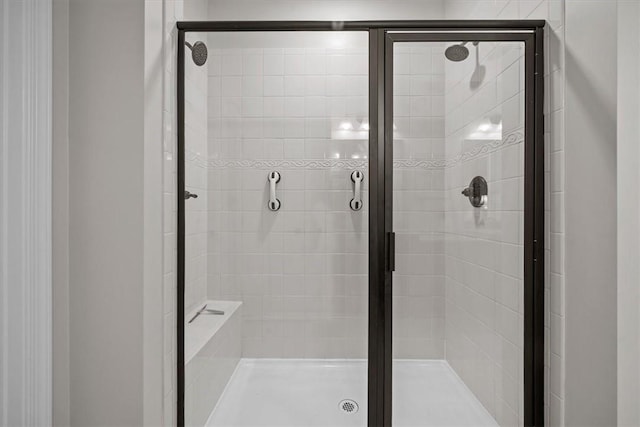 bathroom with a shower with door