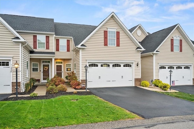 view of front facade with a front yard and a garage