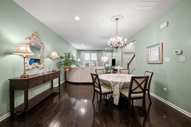 dining space with a notable chandelier and dark wood-type flooring