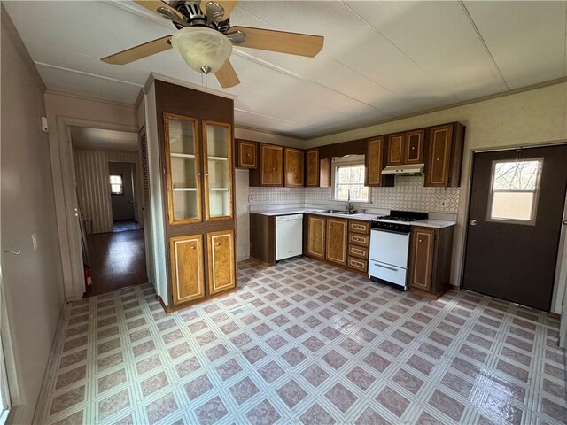 kitchen with sink, white appliances, ceiling fan, and backsplash