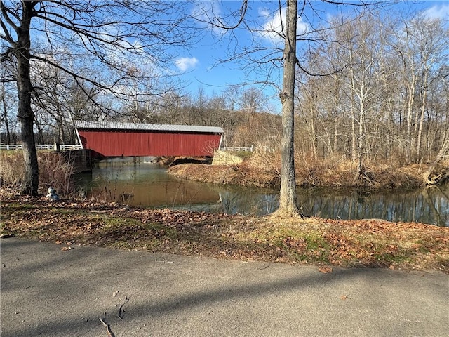 view of property exterior with a water view