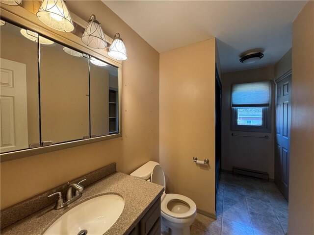 bathroom featuring vanity, a baseboard radiator, and toilet