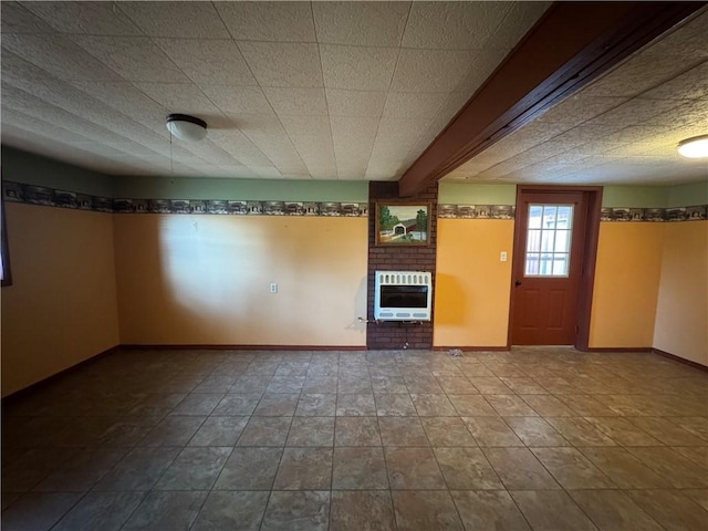 unfurnished living room featuring heating unit and a brick fireplace