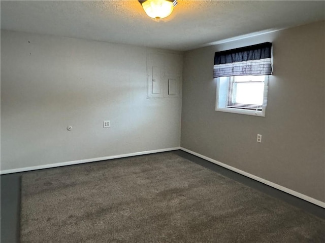 unfurnished room featuring dark carpet