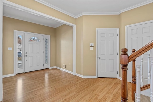 foyer with light hardwood / wood-style floors and ornamental molding