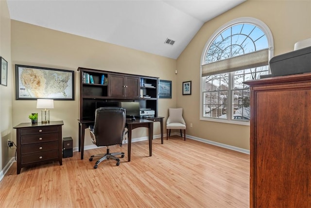 office featuring light wood-type flooring and lofted ceiling