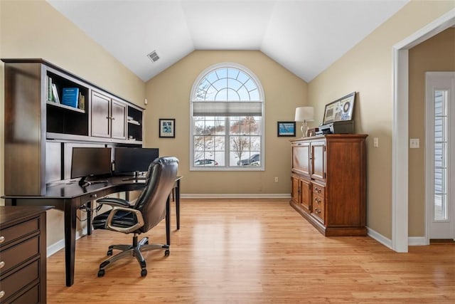 office space featuring light hardwood / wood-style floors and vaulted ceiling