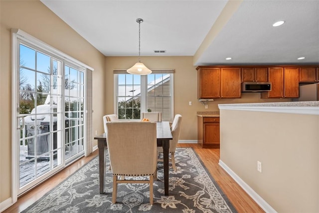 dining area with light hardwood / wood-style floors