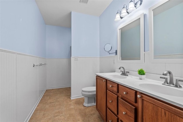 bathroom featuring tile patterned flooring, vanity, and toilet