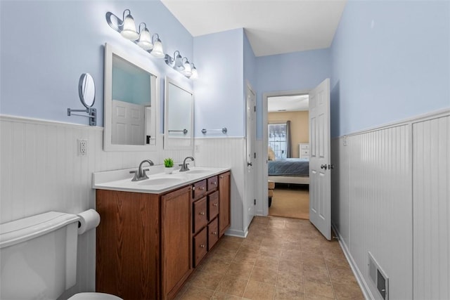 bathroom featuring tile patterned floors, vanity, and toilet