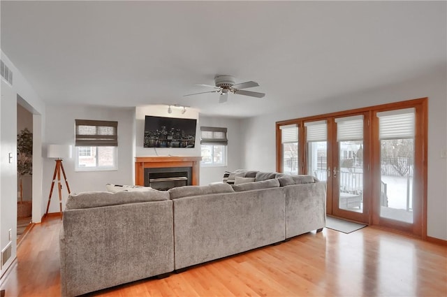 living room featuring ceiling fan and light wood-type flooring