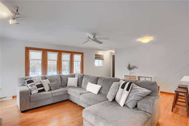 living room with ceiling fan and hardwood / wood-style flooring